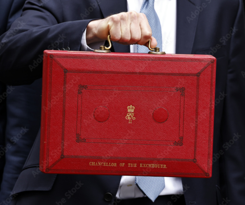 Uk Chancellor holding red briefcase outside 11 Downing Street.